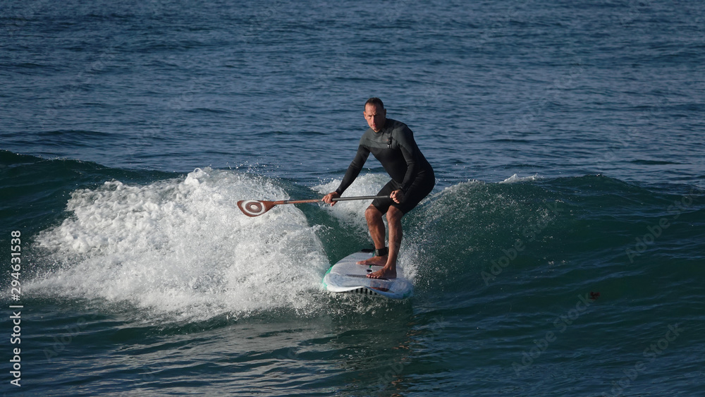 Man surfing with paddle board Man surfing with paddle board