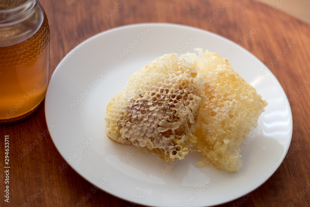 Fresh honey jar and honeycomb, delicious biological product.