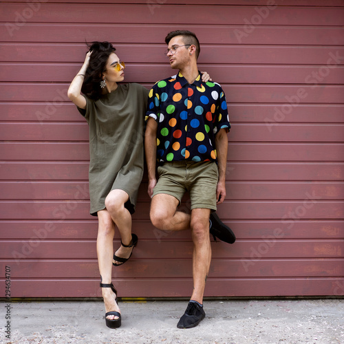 Young fashionable couple on pink background