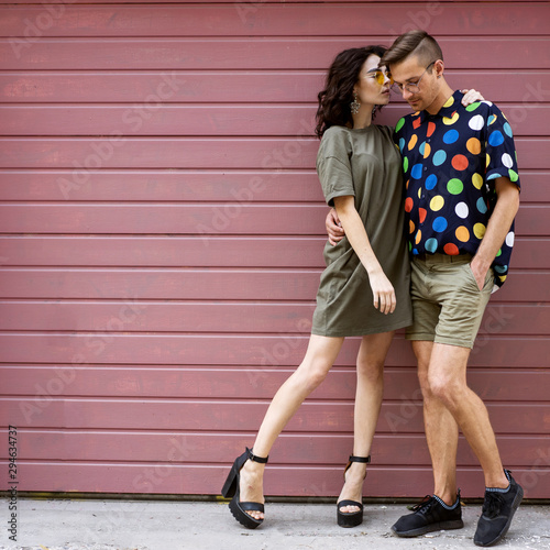 Young fashionable couple on pink background