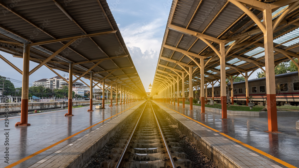 The train tracks in the building have an orange light. The train tracks in the building have an orange light.