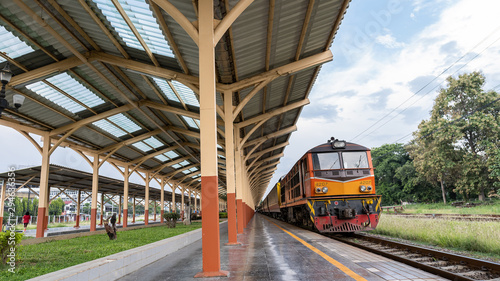 Front view of an orange train traveling