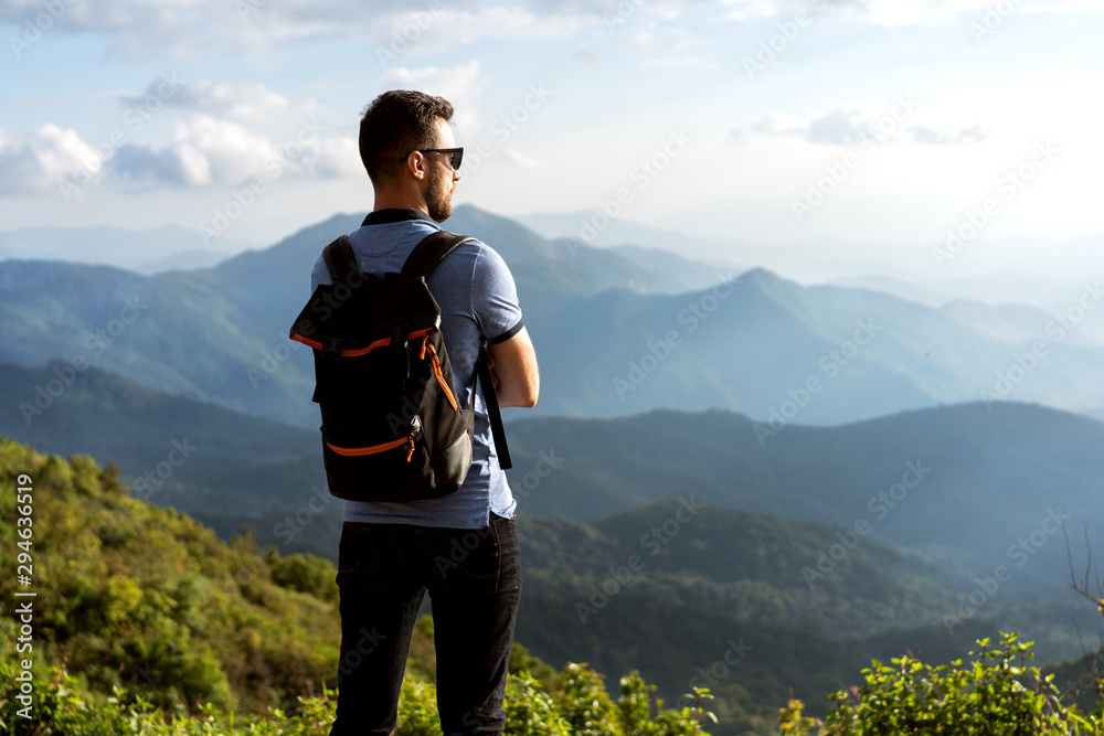 tourist guy stands on the edge of the mountains in thailand