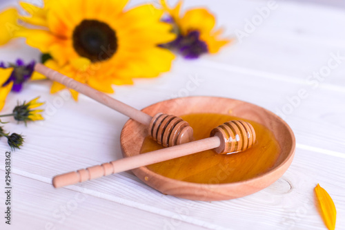 Natural honey with herbs on white wooden background. Organic food, healthy food, sugar dessert © Andreshkova Nastya