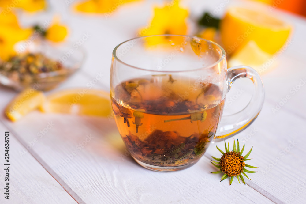 Herbal natural hot tea with different herbs,lemon and honey. Vitamins, healthy lifestyle concept