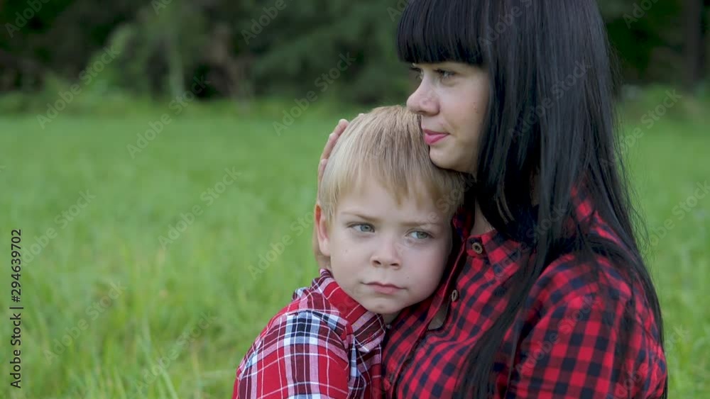 happy family mom and son concept . mom tender childhood video . slow motion video . mom a brunette girl gently hugs takes care of the boy son lifestyle blonde outdoors happy family mom and son concept . mom tender childhood video . slow motion video . mom a brunette girl gently hugs takes care of the boy son lifestyle blonde outdoors