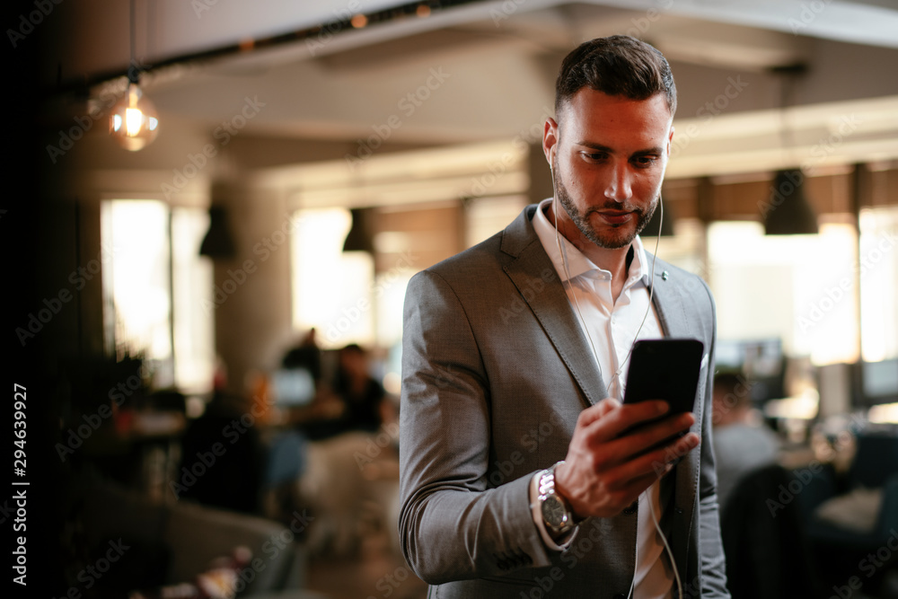 Businessman in grey suit using phone Businessman in grey suit using phone