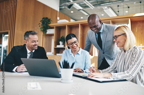Diverse group of businesspeople laughing together during an offi