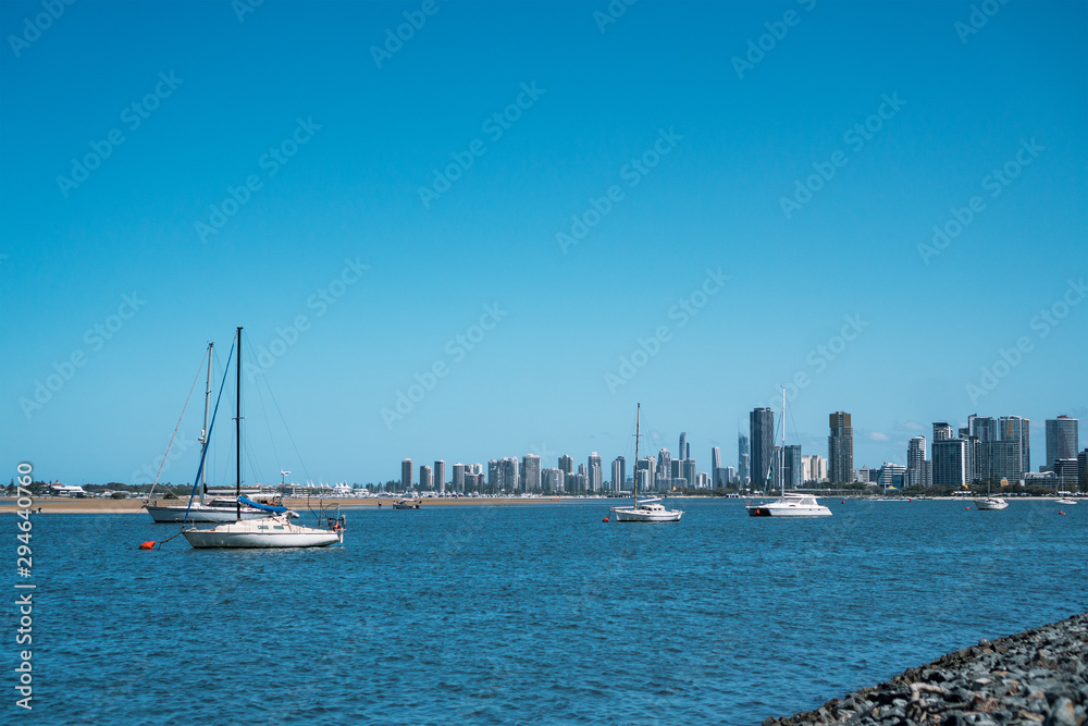 Beautiful view of white yachts and fishing boats cruising the stunning Broadwater, the Gold Coast's premier waterfront in Australia.