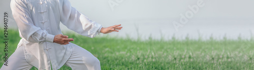 Fotografia Asian man working out with Tai Chi in the morning at the park, Chinese martial arts, healthy care for life concept