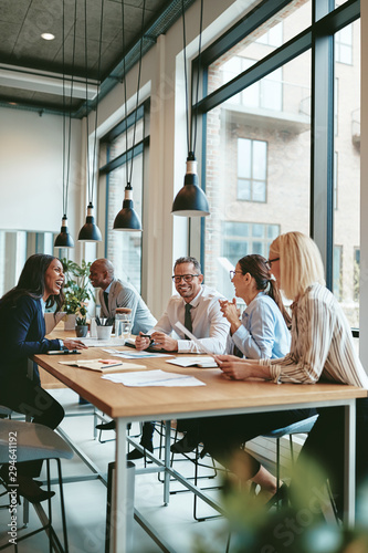 Smiling group of diverse businesspeople meeting together in an o