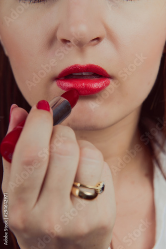 Professional Make-up. Applying red liptick