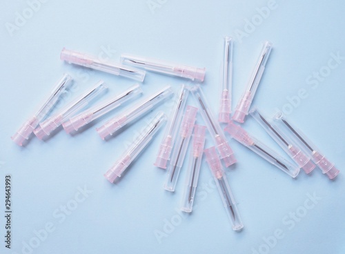 injection needle hypodermic syringe medical equipment for treatment isolated on blue background.