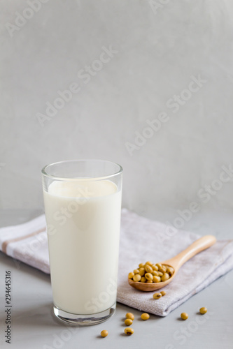 Soy milk in a glass glass. Vegetarian food. Organic products, healthy food concept. Vertical orientation, side view, copy space.