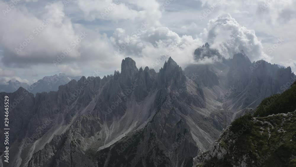 Man Alone on Top of the Mountain Aerial Drone 4K View with Cloudy Mountains. Italy Dolomites 4k Footage Flat Profile Ready For Grading. Man Alone on Top of the Mountain Aerial Drone 4K View with Cloudy Mountains. Italy Dolomites 4k Footage Flat Profile Ready For Grading.