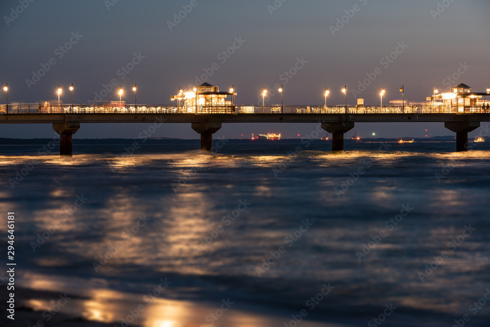 Baltic sea at beautiful sunset in Miedzyzdroje beach. Polish baltic coast. Famous city among the tourist. Pier at sunset
