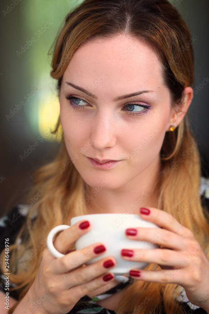 pensive and smiling woman with a cup of coffee pensive and smiling woman with a cup of coffee