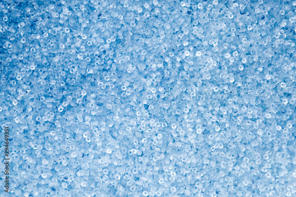 The pile of light blue plastic pellet. The resin material from the petrochemical processing for injection process.