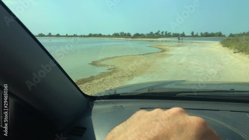 Shoot from windshield of car. movement along a sandy beach
