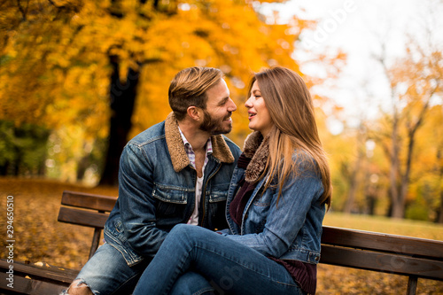 Young loving couple on a bench in autumn park