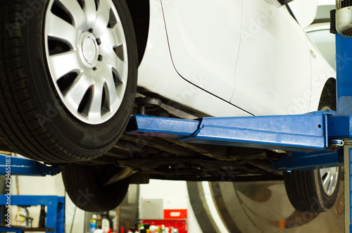 white color car service hydraulic ramp lift car  forward down view