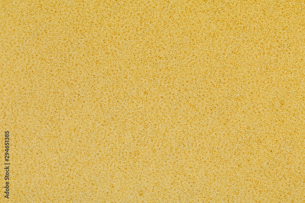 yellow polyurethane foam rubber pieces background texture. stuffing for pillows and furniture - obrazy, fototapety, plakaty 