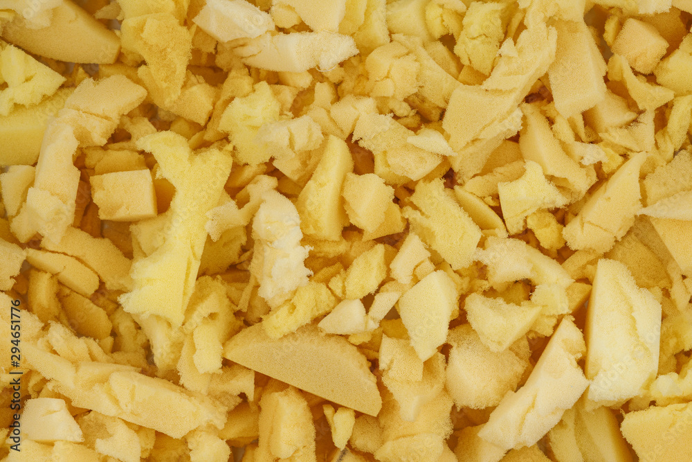 yellow polyurethane foam rubber pieces background texture. stuffing for pillows and furniture yellow polyurethane foam rubber pieces background texture. stuffing for pillows and furniture