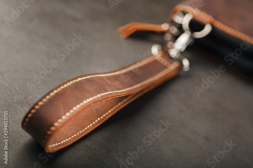 Organizer wallet made of brown Genuine leather, handmade on a dark background