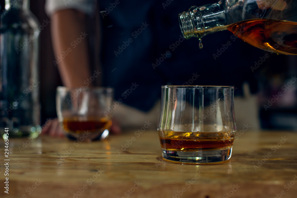 glass of whiskey and cigar on wooden table