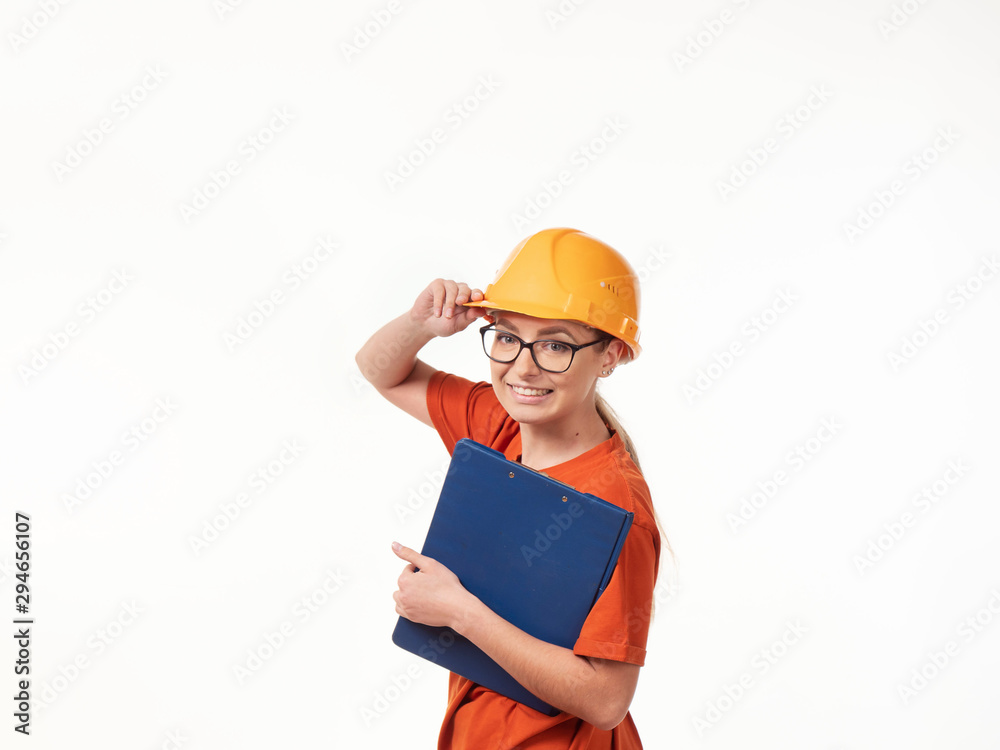 beautiful foreman girl in a yellow helmet with a blue folder on a white background