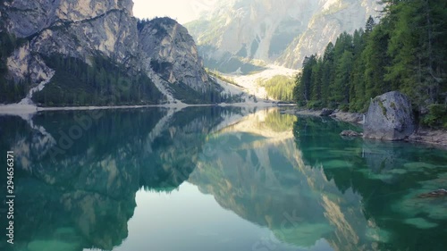 Man Alone on a Lake Aerial 4K Cinematic Shot with Mountain Lake.Italy Dolomites 4k Footage Drone Shot in UHD 4K