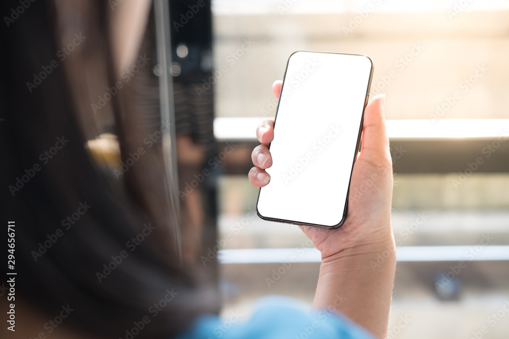 A women hand holding smart phone with blank screen. Mockup screen.