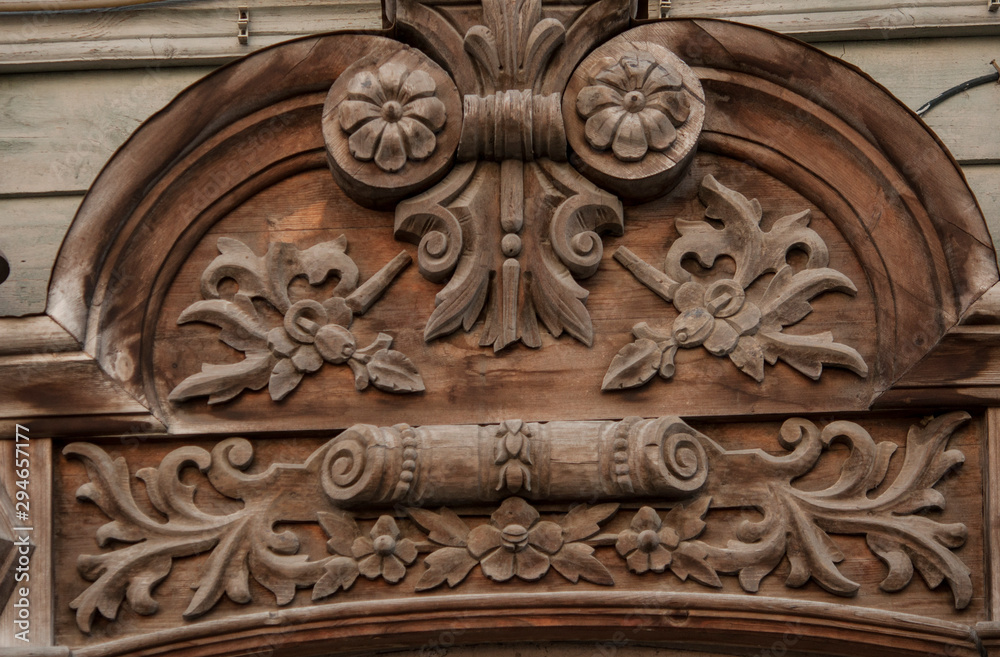 Vintage carved wooden decoration frequently used on windows in urban buildings.