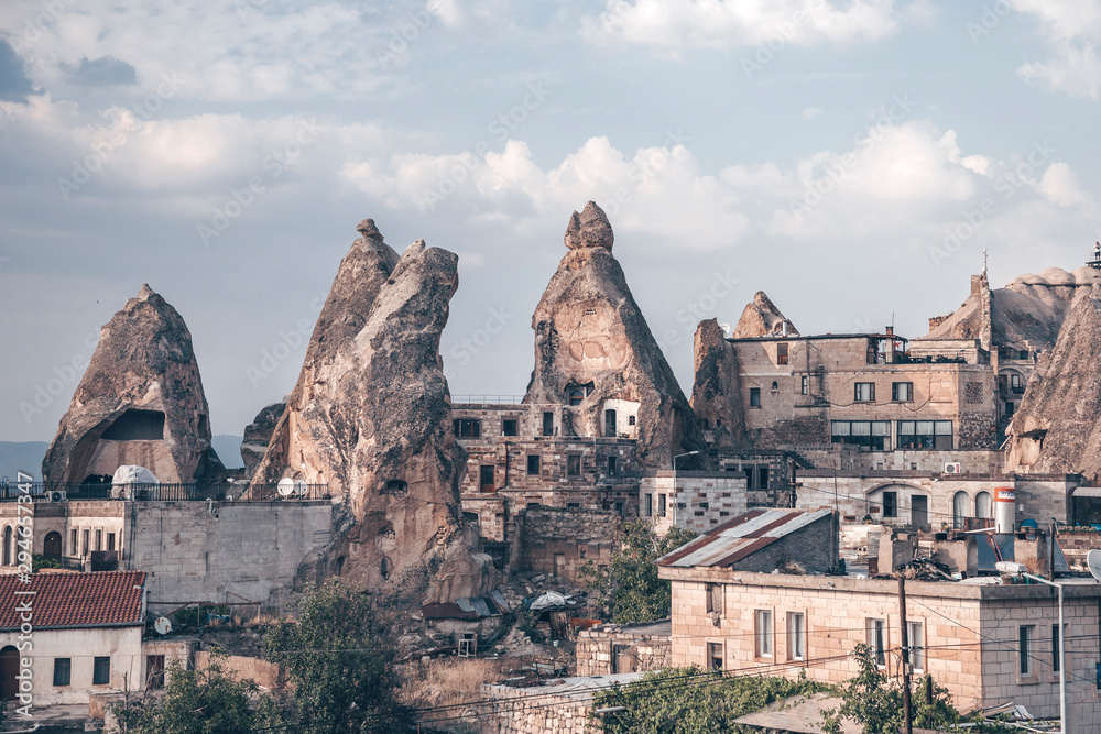 Cave houses and buildings in Cappadocia, Turkey. Stone peaks with doors and windows. Dwelling in real caves