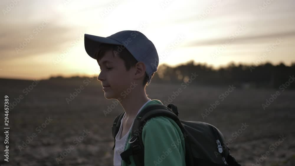 boy with backpack walking at sunset outdoors, travel boy with backpack walking at sunset outdoors, travel