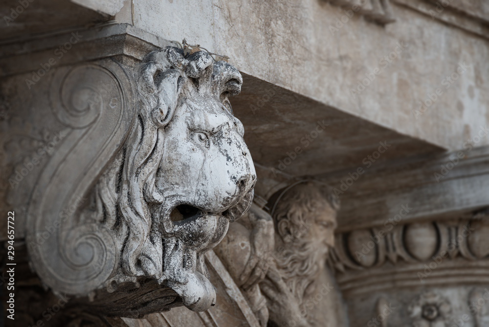 Ancient decoration element of scary lion head at roof of Basilica San Marco and Doge Palace in Venice, Italy Ancient decoration element of scary lion head at roof of Basilica San Marco and Doge Palace in Venice, Italy