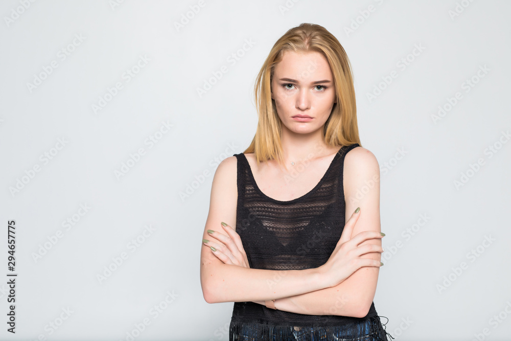 Young woman with crossed hands isolated on gray background Young woman with crossed hands isolated on gray background