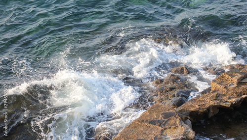 Blue water and rocky coast of the Aegean Sea as a background