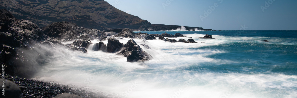 Ocean waves coming in over black stone beach on Lanzarote, Canary islands