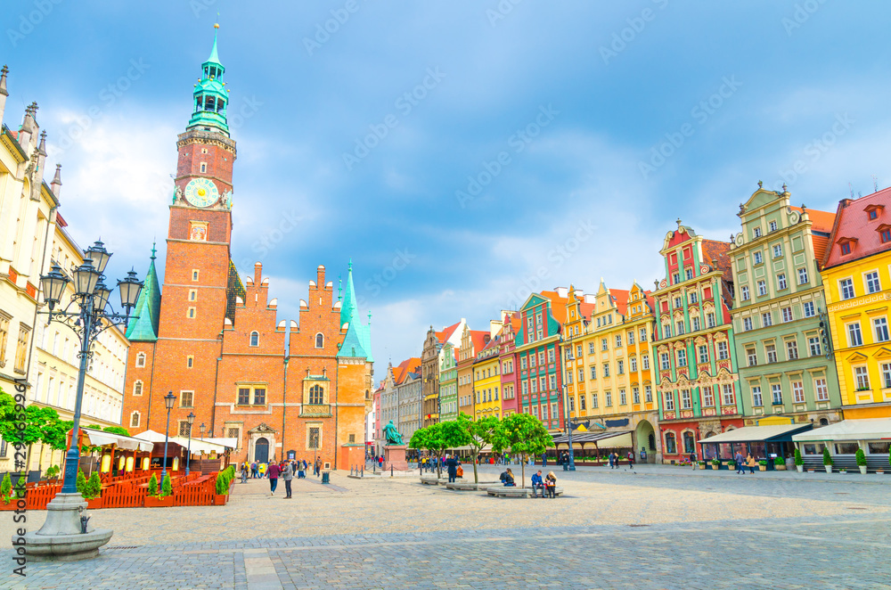 Fototapeta premium Old Town Hall building, row of colorful buildings with multicolored facade and street lamp on cobblestone Rynek Market Square in old town historical city centre of Wroclaw, Poland