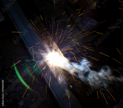 Sparks from welding at a construction site as a background