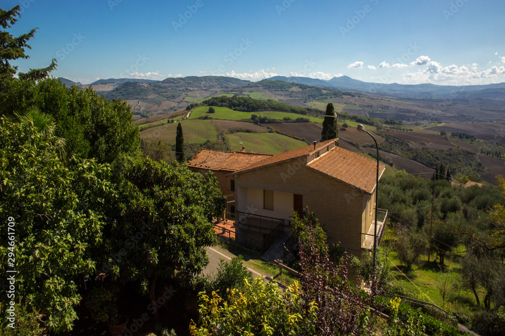 View of a house in the middle of the Tuscan countryside, in Italy.