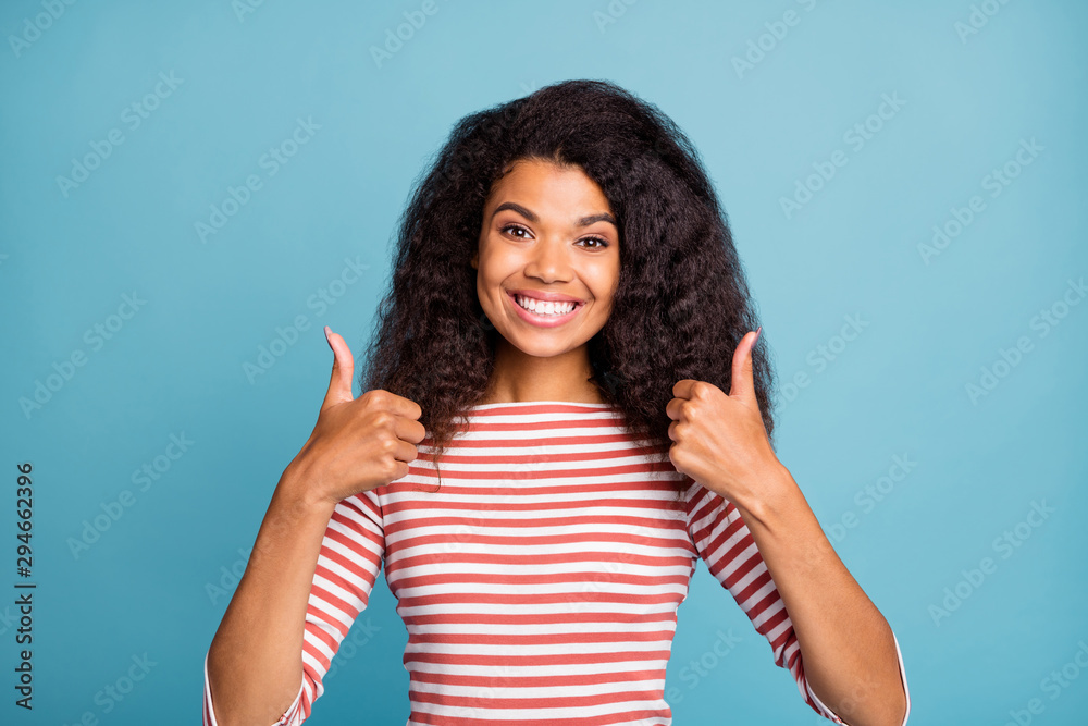Close-up portrait of her she nice attractive lovely cheerful cheery wavy-haired girl wearing striped pullover showing two double thumbup advert ad isolated over blue turquoise pastel color background Close-up portrait of her she nice attractive lovely cheerful cheery wavy-haired girl wearing striped pullover showing two double thumbup advert ad isolated over blue turquoise pastel color background