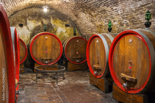Series of barrels preserved in an Italian cellar for wine fermentation.