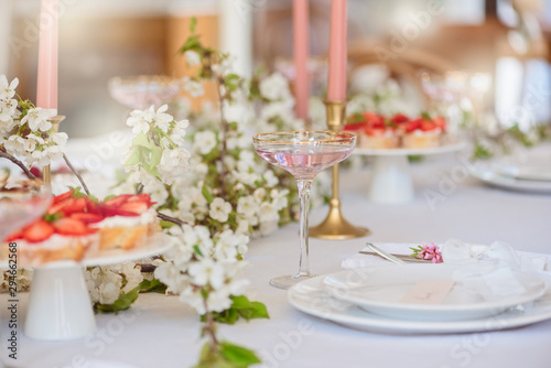 Fruits martini in a festive glass, wedding boho`s table, a cake with flowers