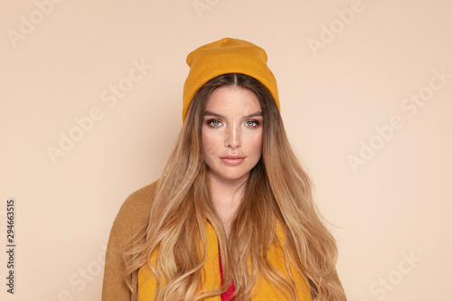 Fashionable girl in autumn yellow cap.
