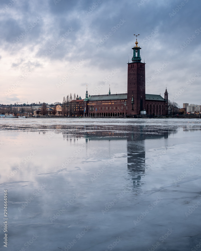 The city hall in stockholm reflected in the icy in winter time