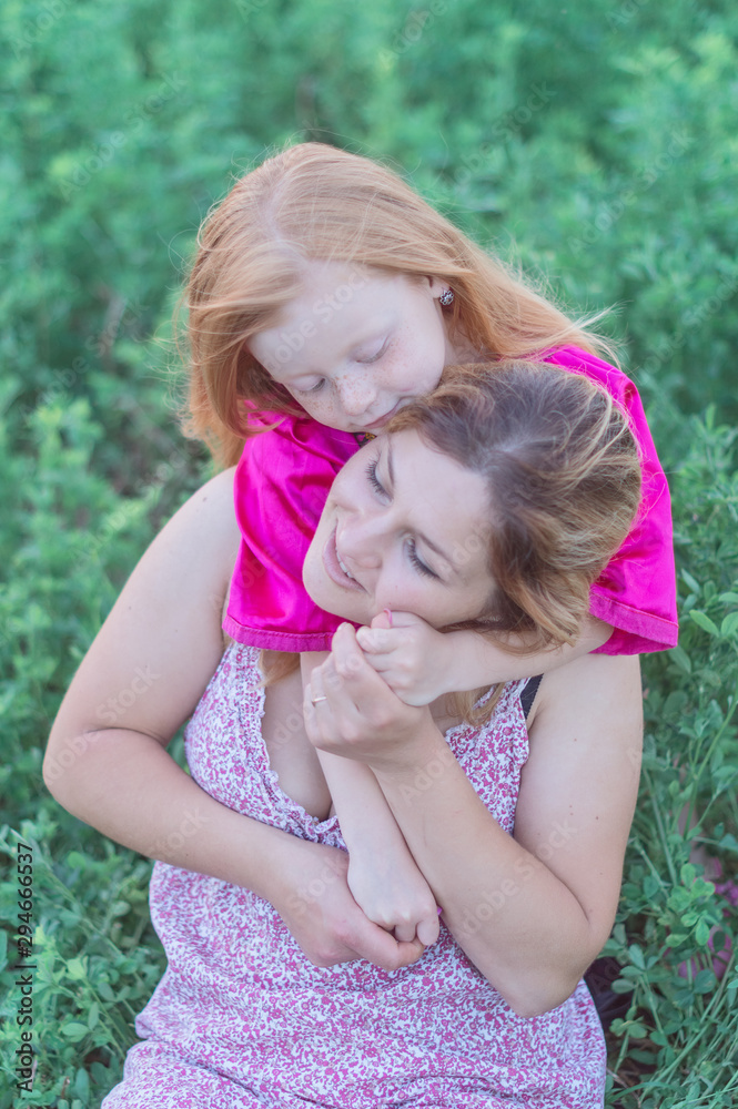 Happy mother with her daughter in a field Happy mother with her daughter in a field