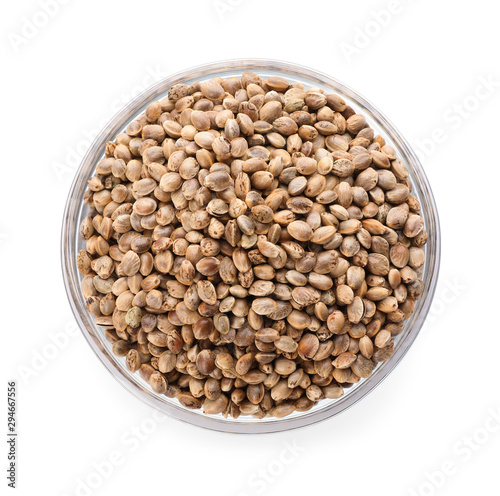 Glass bowl of hemp seeds on white background, top view