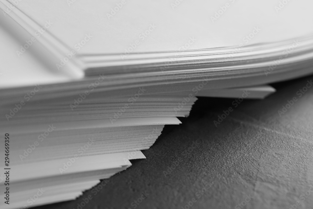 Stack of blank paper on grey stone table, closeup Stack of blank paper on grey stone table, closeup